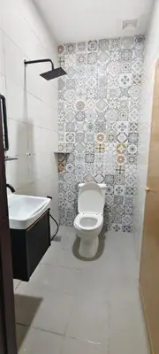 a bathroom with a toilet and a sink at 3Q Impiana Roomstay Teluk Senangin in Lumut