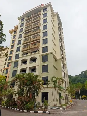 a tall white building with palm trees in front of it at Azure Haven by the Sea-Lumut in Lumut