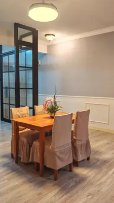 a dining room with a wooden table and chairs at Azure Haven by the Sea-Lumut in Lumut