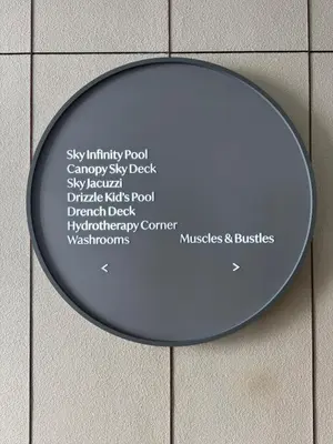 a round mirror on a wall with words on it at Lovecozy Home 22M Macalister in George Town