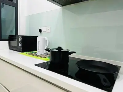 a kitchen counter with a black pot and a microwave at Luxury Sea view Sunset view Jazz Suites near Gurney in Tanjong Tokong