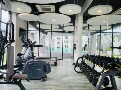 a gym with treadmills and ellipticals in a building at Luxury Sea view Sunset view Jazz Suites near Gurney in Tanjong Tokong