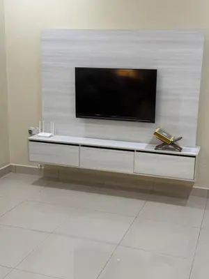 a flat screen tv on a wall in a living room at De Ipoh Homestay in Tanjung Rambutan