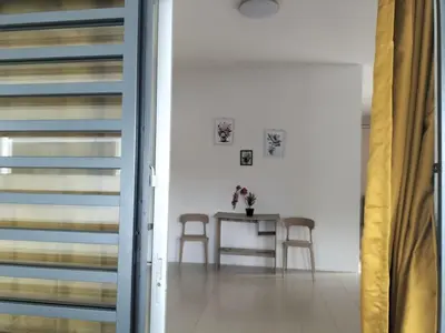 a dining room with a table and two chairs at \u5de5\u4e1a\u4f4f\u5bb6 in Lahat