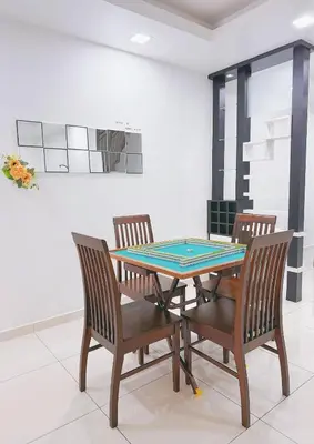 a dining room with a ping pong table and chairs at Cozy Homestay 6-10pax Double storey in Bukit Mertajam