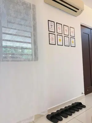 a room with a white wall and a window at Cozy Homestay 6-10pax Double storey in Bukit Mertajam