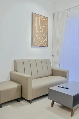 a living room with a couch and a coffee table at Picaddily Suites by Homexa Hospitality in Ipoh