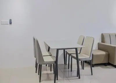 a table and chairs in a waiting room at Picaddily Suites by Homexa Hospitality in Ipoh