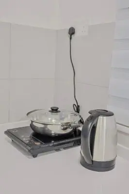 a glass bowl on a tray next to a tea kettle at Picaddily Suites by Homexa Hospitality in Ipoh