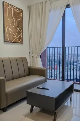 a living room with a couch and a coffee table at Picaddily Suites by Homexa Hospitality in Ipoh