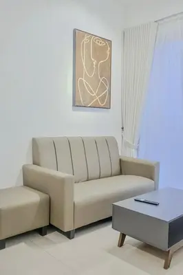 a living room with a couch and a coffee table at Picaddily Suites by Homexa Hospitality in Ipoh