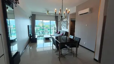 a dining room and living room with a dining table at Kinta Riverfront Apartment Riverview Apartment in Ipoh