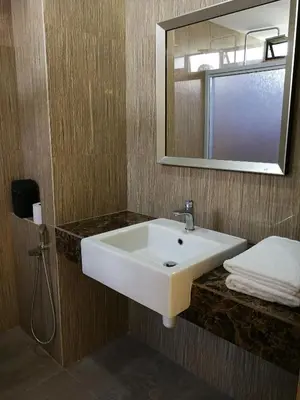 a bathroom with a white sink and a mirror at Isabella Villa George Town Penang in George Town