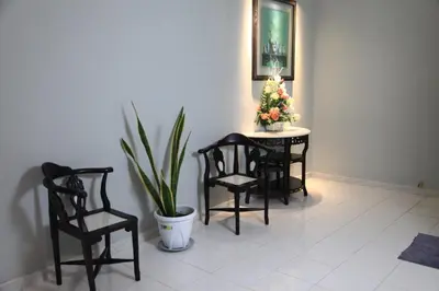a room with a table and two chairs and a potted plant at Isabella Villa George Town Penang in George Town