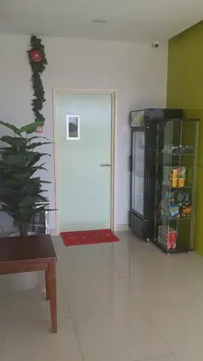a room with a door and a potted plant at Amigo Hotel in Seri Iskandar