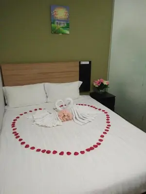 a bed with a heart made out of roses at Amigo Hotel in Seri Iskandar