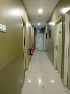 an empty hallway in a hospital with a hallway at Amigo Hotel in Seri Iskandar