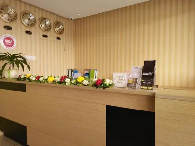 a reception counter with flowers on top of it at Amigo Hotel in Seri Iskandar