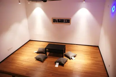a room with a table and two pillows on a wooden floor at Shamrock Seaview 11 Villa in Batu Ferringhi