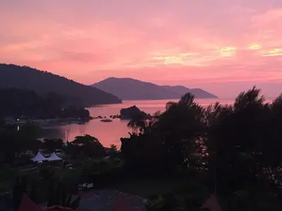 a view of a body of water at sunset at Shamrock Seaview 11 Villa in Batu Ferringhi
