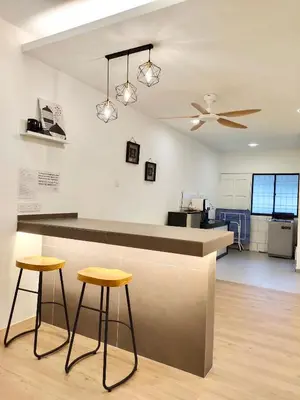 a kitchen with two stools and a counter top at Sakura 1 Homestay Kampar Landed in Kampar