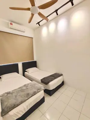 a room with two beds and a ceiling fan at Sakura 1 Homestay Kampar Landed in Kampar
