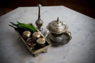 a table with a tea kettle and a tray of balls at Jawi Peranakan Mansion in George Town