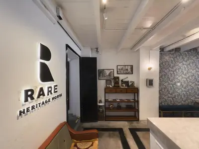 a room with a ra healthcare sign on the wall at RARE Heritage House in George Town