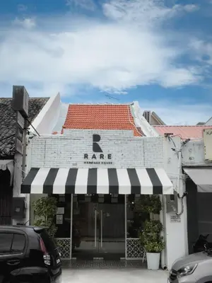 a building with a black and white awning at RARE Heritage House in George Town