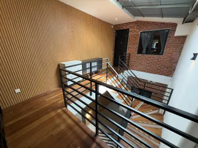 a staircase in a room with a brick wall at RARE Heritage House in George Town