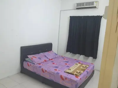 a small bed in a room with a window at The Simple Homestay in Simpang Pulai