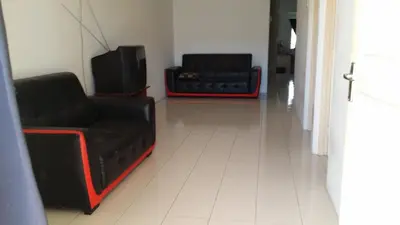 a living room with two chairs and a couch at The Simple Homestay in Simpang Pulai