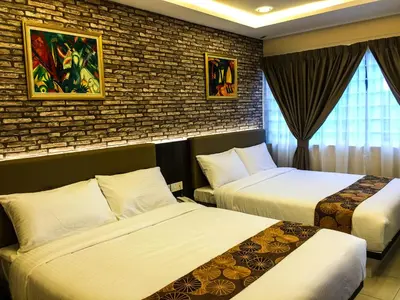 a hotel room with two beds and a brick wall at Louis Hotel in Taiping