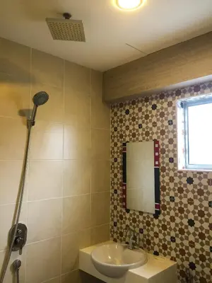 a bathroom with a sink and a mirror at Louis Hotel in Taiping