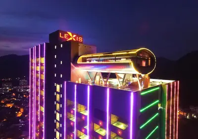 a lit up building with a sign on top of it at Lexis Suites Penang in Bayan Lepas