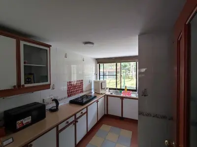 a kitchen with a counter and a microwave in it at Mary Apt @ Equatorial Hill Resort in Cameron Highlands