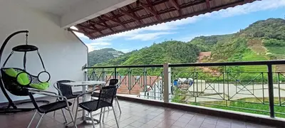 a balcony with a table and chairs and a view at Mary Apt @ Equatorial Hill Resort in Cameron Highlands