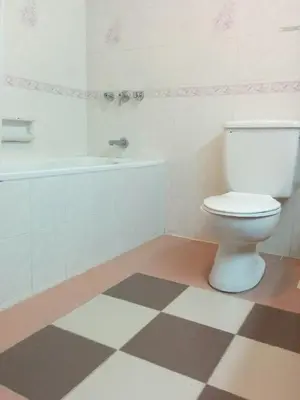a bathroom with a toilet and a bath tub at Mary Apt @ Equatorial Hill Resort in Cameron Highlands