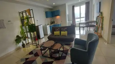 a living room with two chairs and a couch at Merlene Suites at Mansion One Formerly know as Mansion One Suites in George Town
