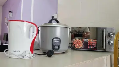 a kitchen counter with a food processor and a microwave at Comfort On the Hill in Cameron Highlands