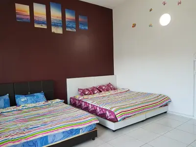 two beds sitting next to each other in a bedroom at Comfort On the Hill in Cameron Highlands