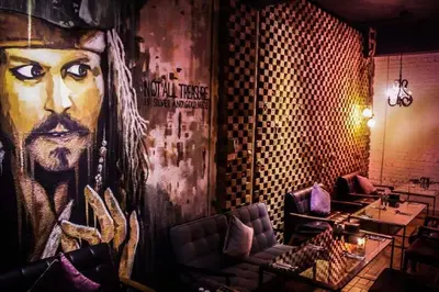 a restaurant with a large painting of a man at Kim Haus Loft in George Town