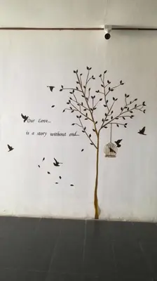 a tree with birds flying around it at Pangkor Home Sea Village in Pangkor