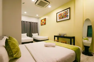 a hotel room with a bed and a sink at Travelland Hotel in Ipoh