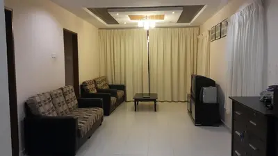 a living room with a couch and a tv at Rose Apartment Kea Farm in Cameron Highlands