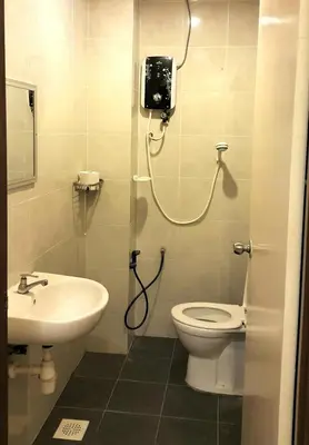 a bathroom with a shower and a toilet and a sink at Rose Apartment Kea Farm in Cameron Highlands