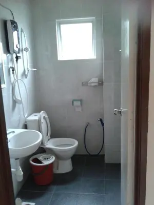 a bathroom with a toilet and a sink and a shower at Rose Apartment Kea Farm in Cameron Highlands