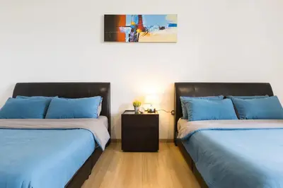 two beds sitting next to each other in a room at 118 Residences by Travovo in George Town