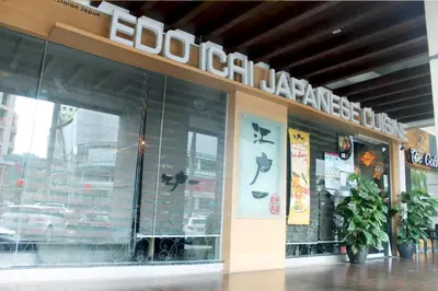 a restaurant with a sign on the side of a building at 118 Residences by Travovo in George Town