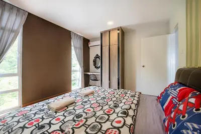 a bedroom with a large bed and a window at New Shamrock Beach Villas Seaview in Batu Ferringhi